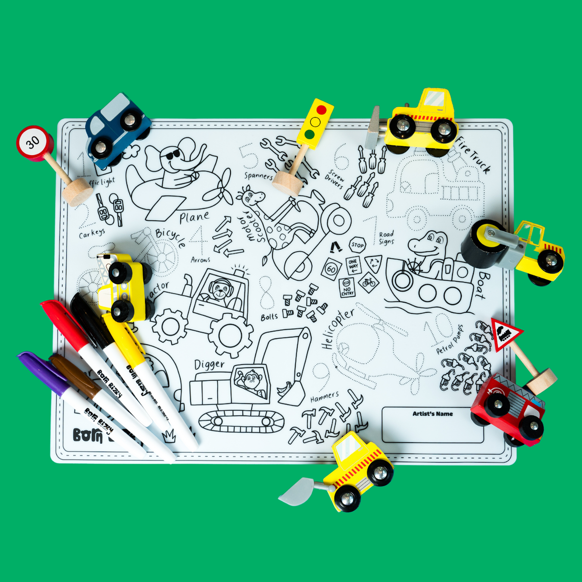 Coloring mat with vehicles, road signs, and markers scattered on a vibrant green background.
