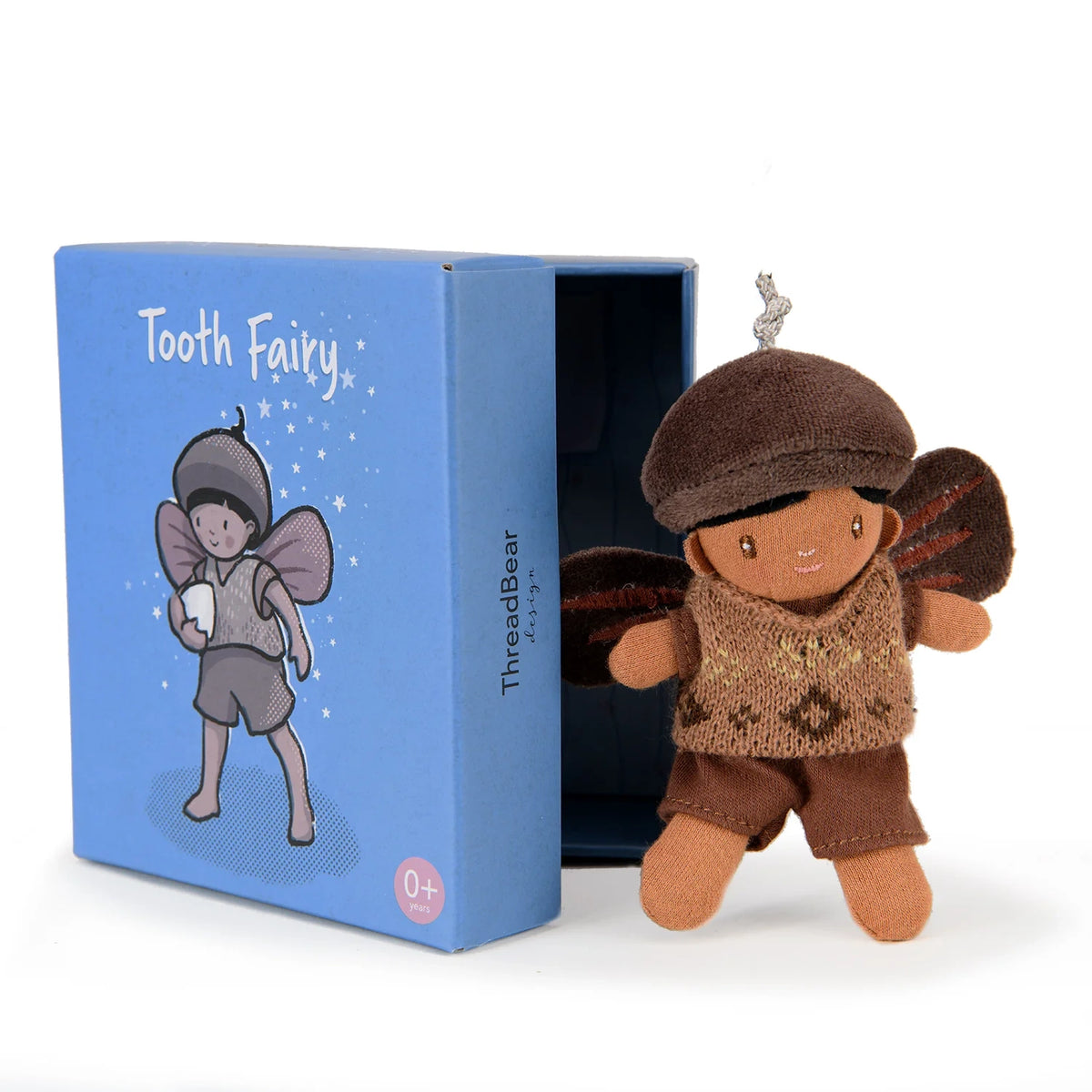 Small plush forest tooth fairy doll peeking out from its blue matchbox-style box.
