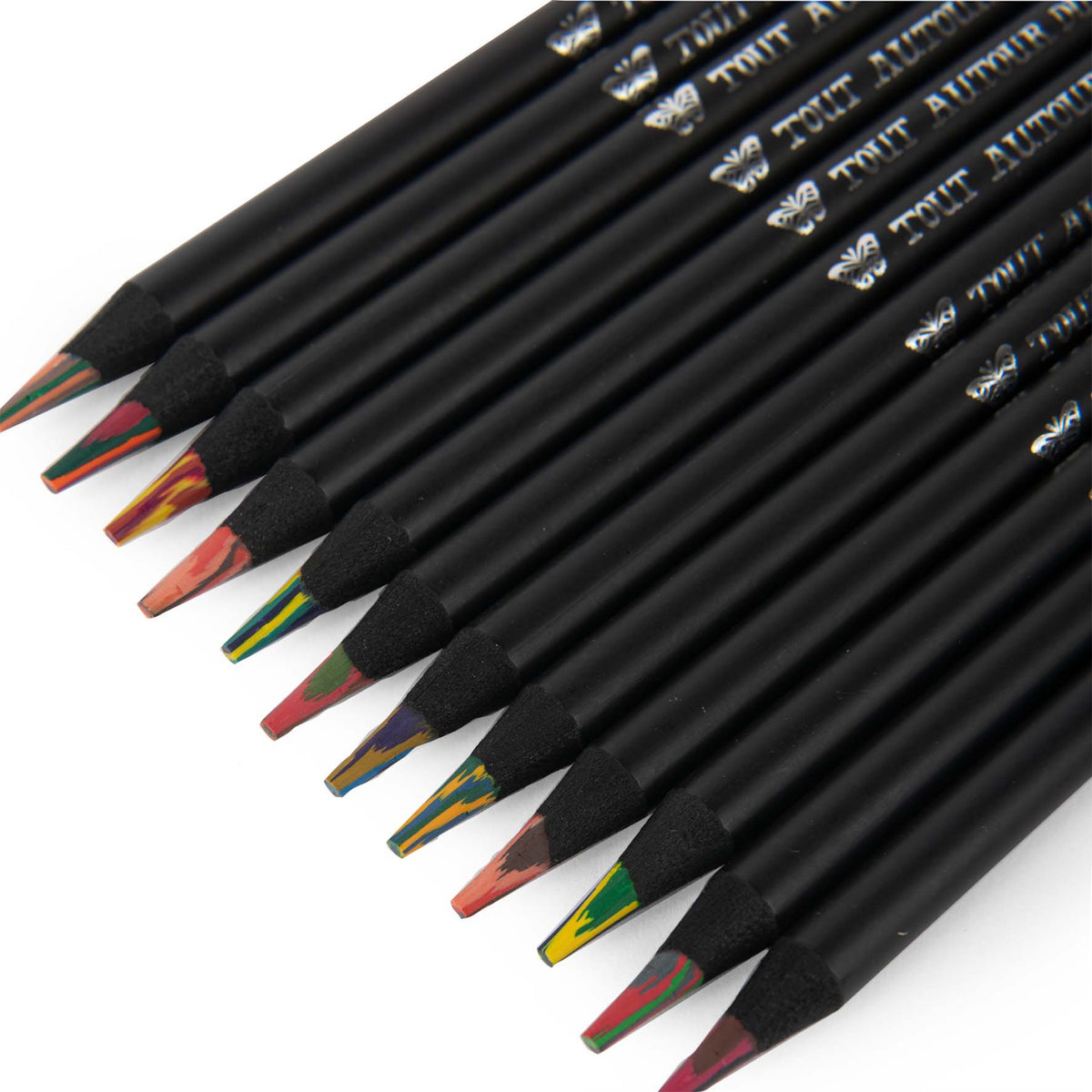 Set of 12 Tout Autour du Monde multicolored pencils with black wood barrels and rainbow cores on a white background.