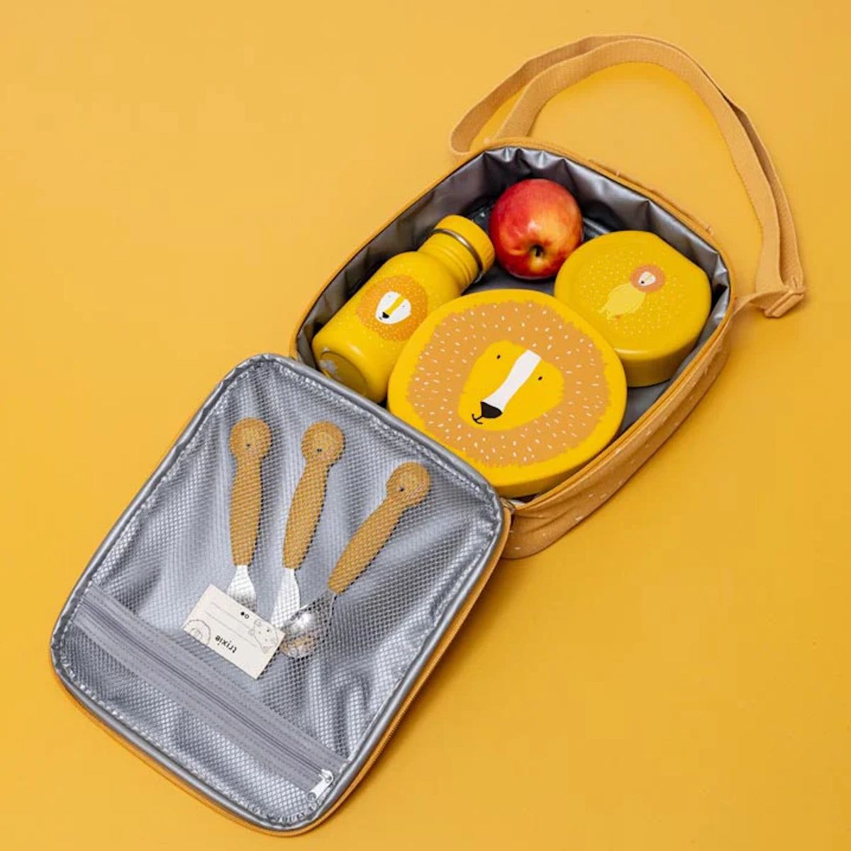 An open yellow lunch bag packed with a red apple and a matching lion-themed water bottle and snack containers.