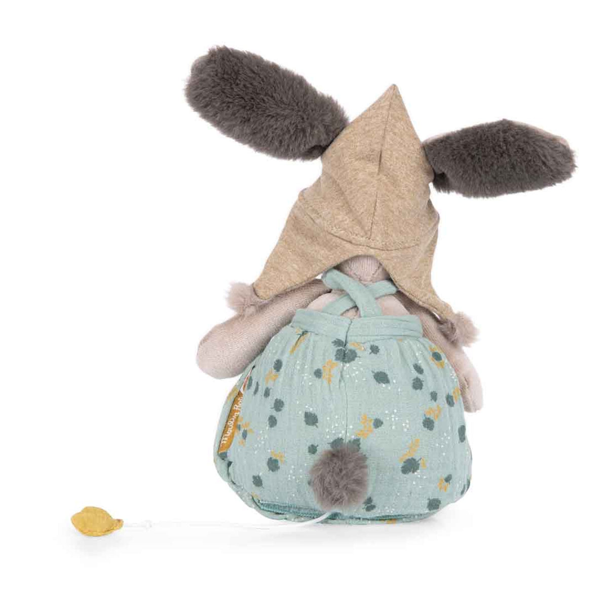 Rear view of a plush rabbit wearing a tan hood and green patterned overalls, featuring a fluffy tail and pull-string.