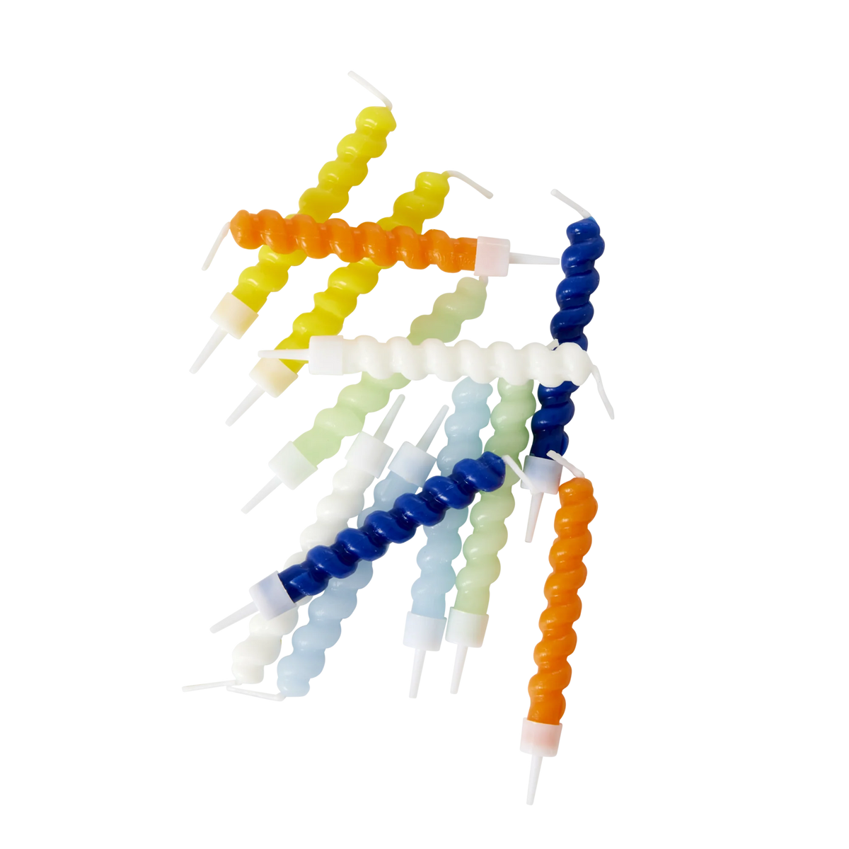Brightly colored spiral candles in hues of blue, orange, yellow, and white are scattered on a white background, creating a playful and vibrant look.