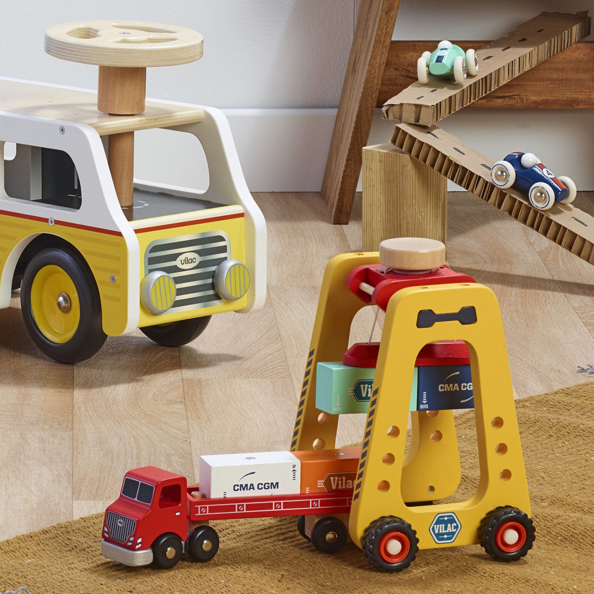 Vilac wooden toy container crane and truck set on a rug in a playroom with other toy cars.