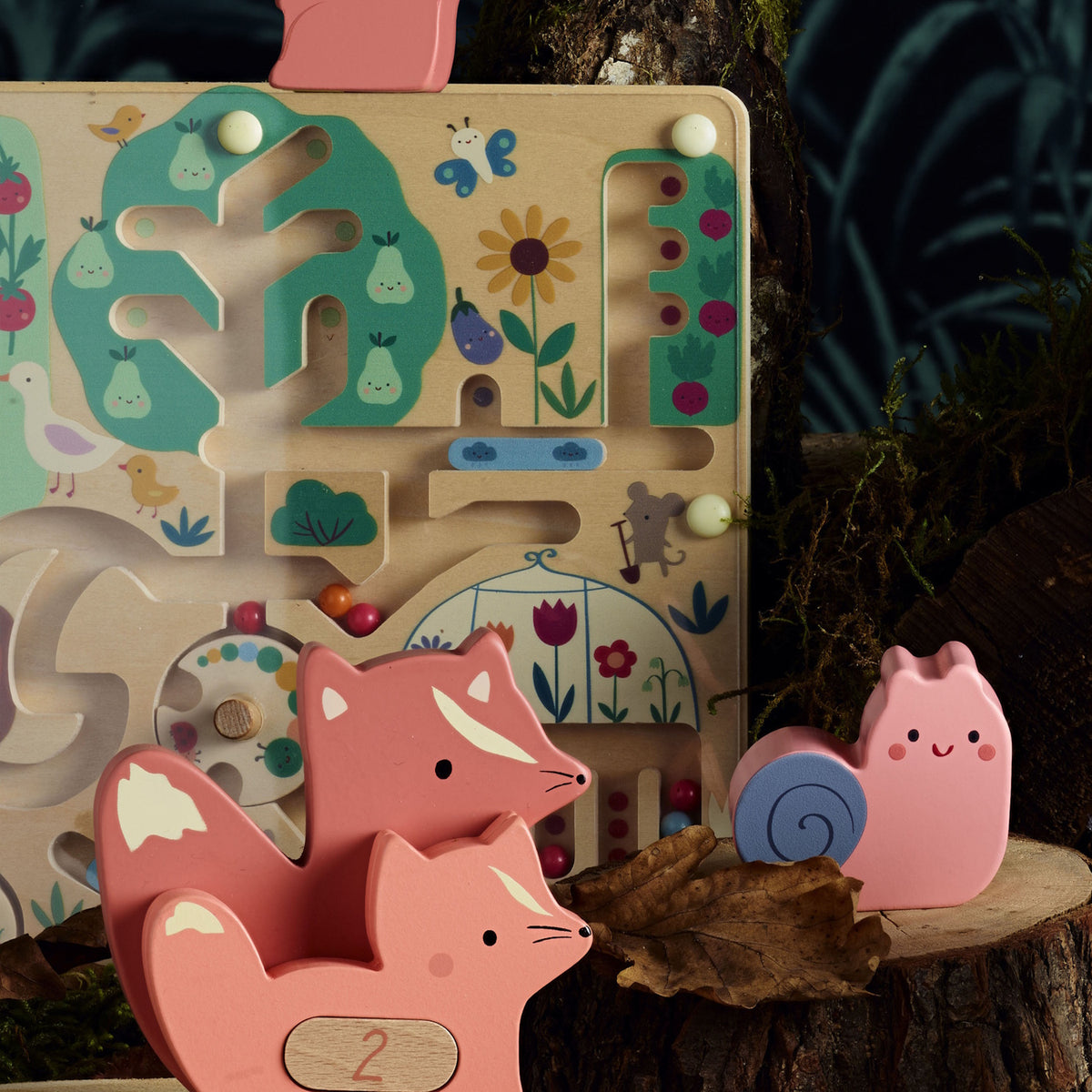 Wooden garden magnetic maze toy with pink wooden animals on a tree stump.