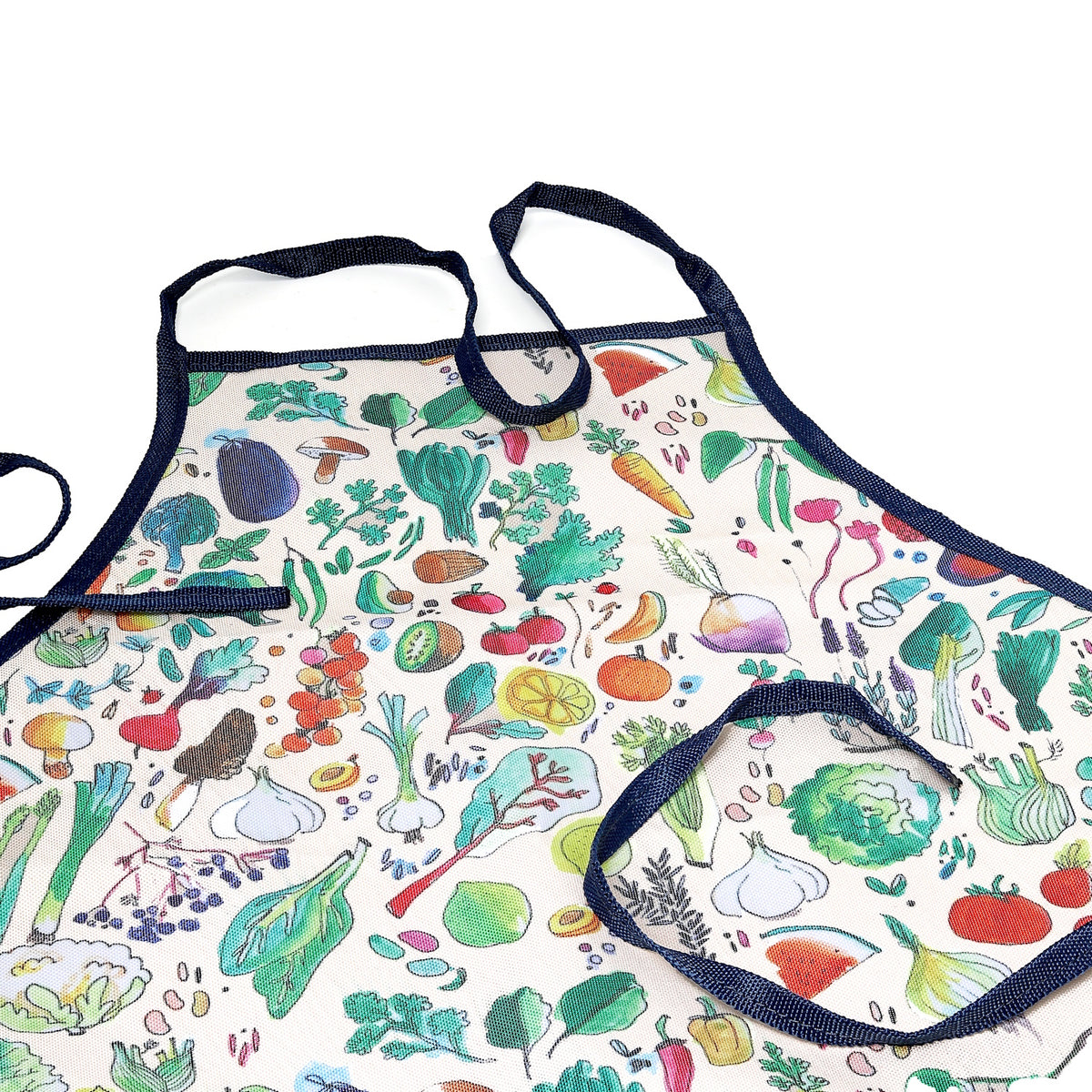 Kitchen apron with a colorful vegetable and herb print, featuring dark blue straps and a matching front pocket.