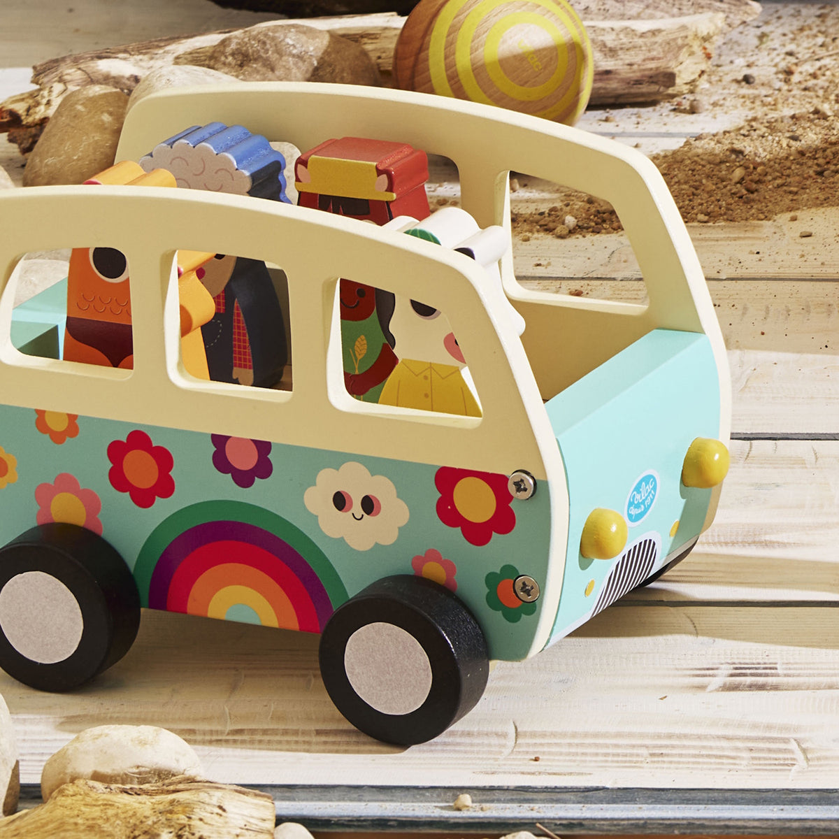 Vilac wooden toy camper bus with colorful rainbow design, filled with wooden animal figures.