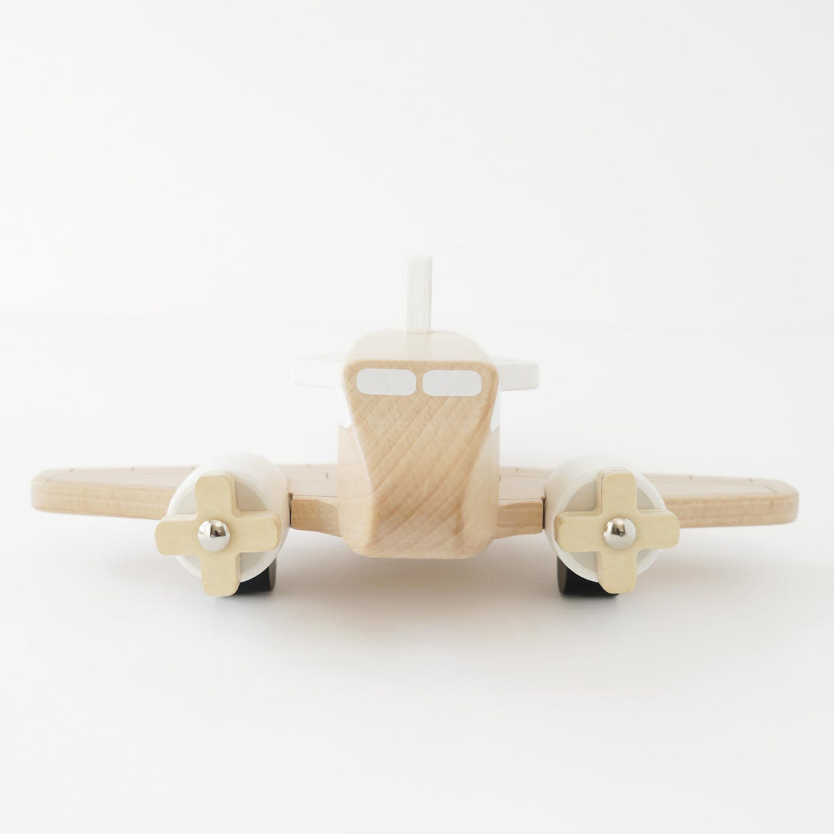 Natural wooden toy airplane with twin propellers, front view on a white background.