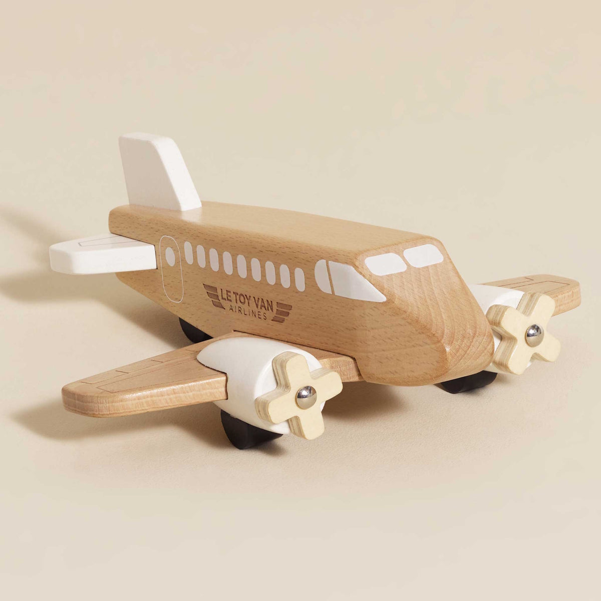 Natural wooden toy airplane with white accents and two propellers.