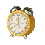 Side view of the Maileg alarm clock in yellow, featuring silver accents on the bells and legs