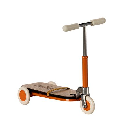 Maileg mouse kickboard scooter in bright orange with cream wheels and handlebars.