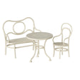 A charming Maileg café set for mice in off white, featuring a round metal table with a delicate punched flower pattern, accompanied by a matching chair and bench.