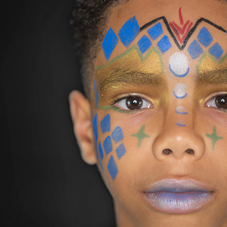 A child with intergalactic-themed face paint, including blue and gold patterns with starry details.