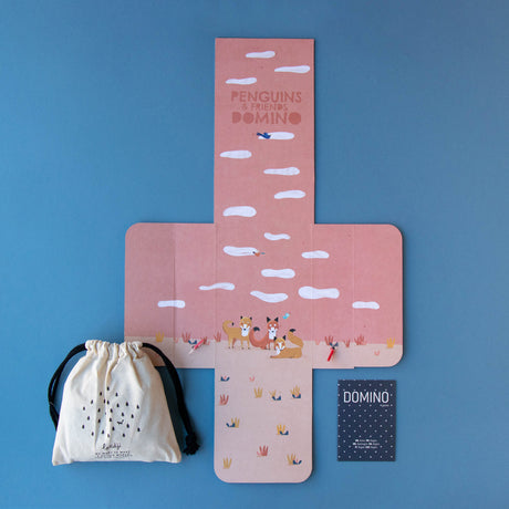Unfolded packaging of Penguins & Friends Domino – The open game box with an illustrated background, instruction booklet, and a fabric storage bag.