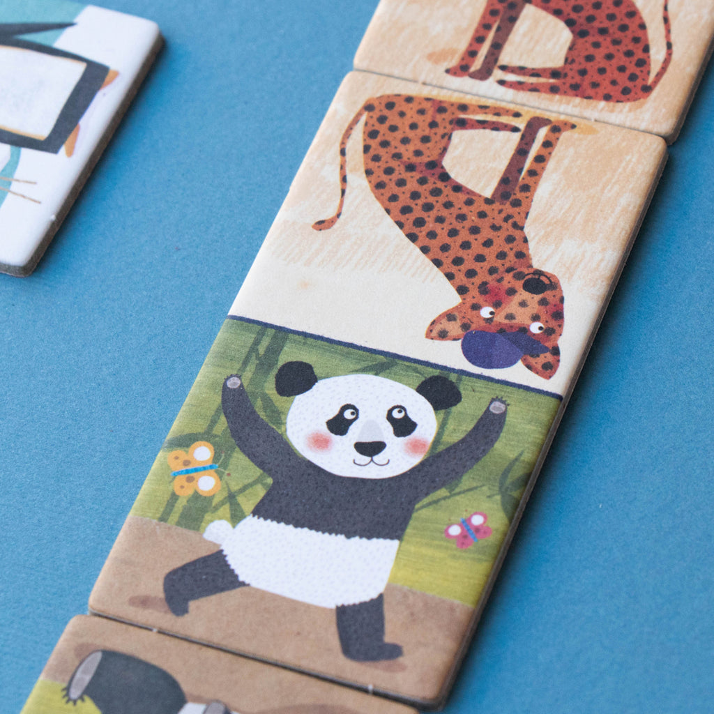 Close-up of Londji domino pieces featuring a panda and a leopard – A detailed shot of two connected domino tiles with a panda and a leopard.