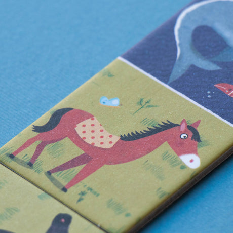 Close-up of Londji domino piece featuring a horse and a dolphin – A beautifully illustrated domino tile with a brown horse and a dolp