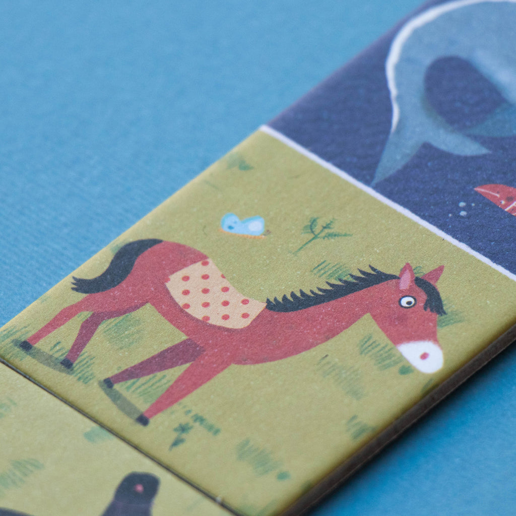 Close-up of Londji domino piece featuring a horse and a dolphin – A beautifully illustrated domino tile with a brown horse and a dolp