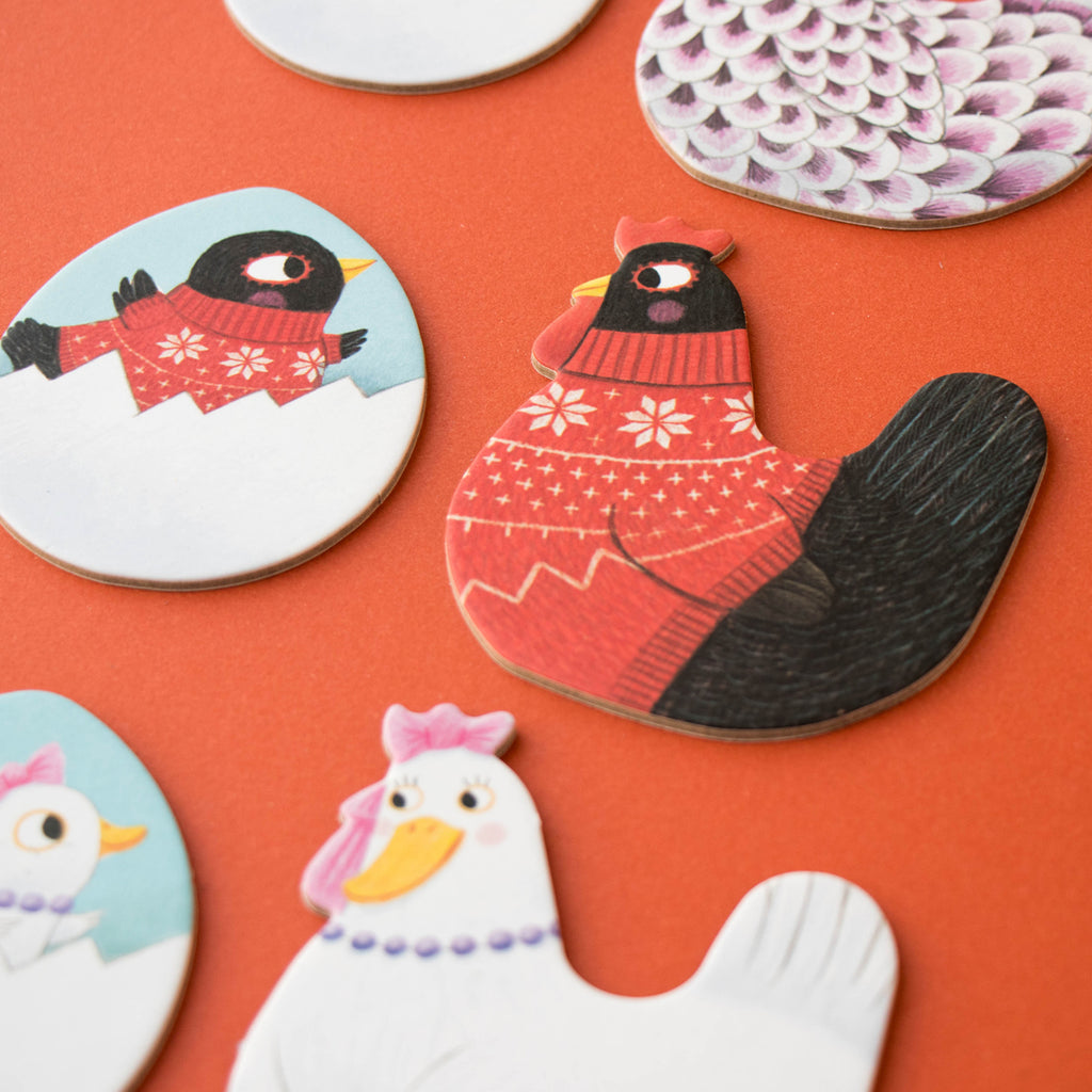 Close-up of the Chicks & Chickens memory game pieces, featuring a black hen in a red knitted jumper.