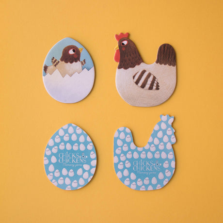 Four game pieces, including a hen, a chick, and the patterned backs of the memory game tiles.