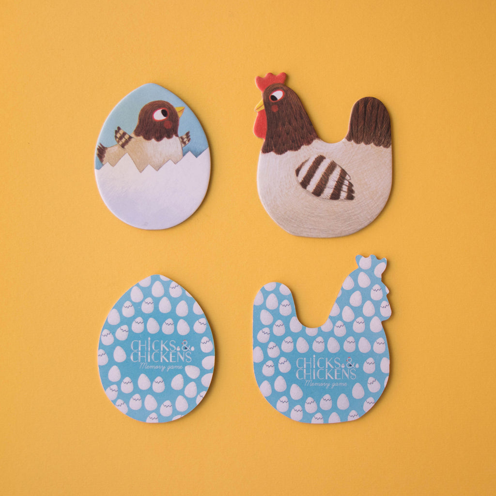 Four game pieces, including a hen, a chick, and the patterned backs of the memory game tiles.