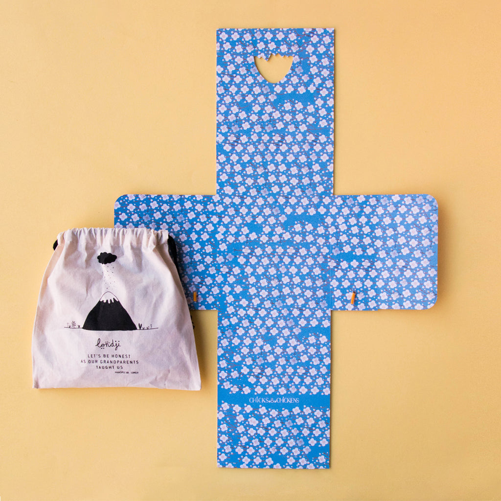 Chicks & Chickens memory game laid out with a drawstring storage bag and patterned game board.
