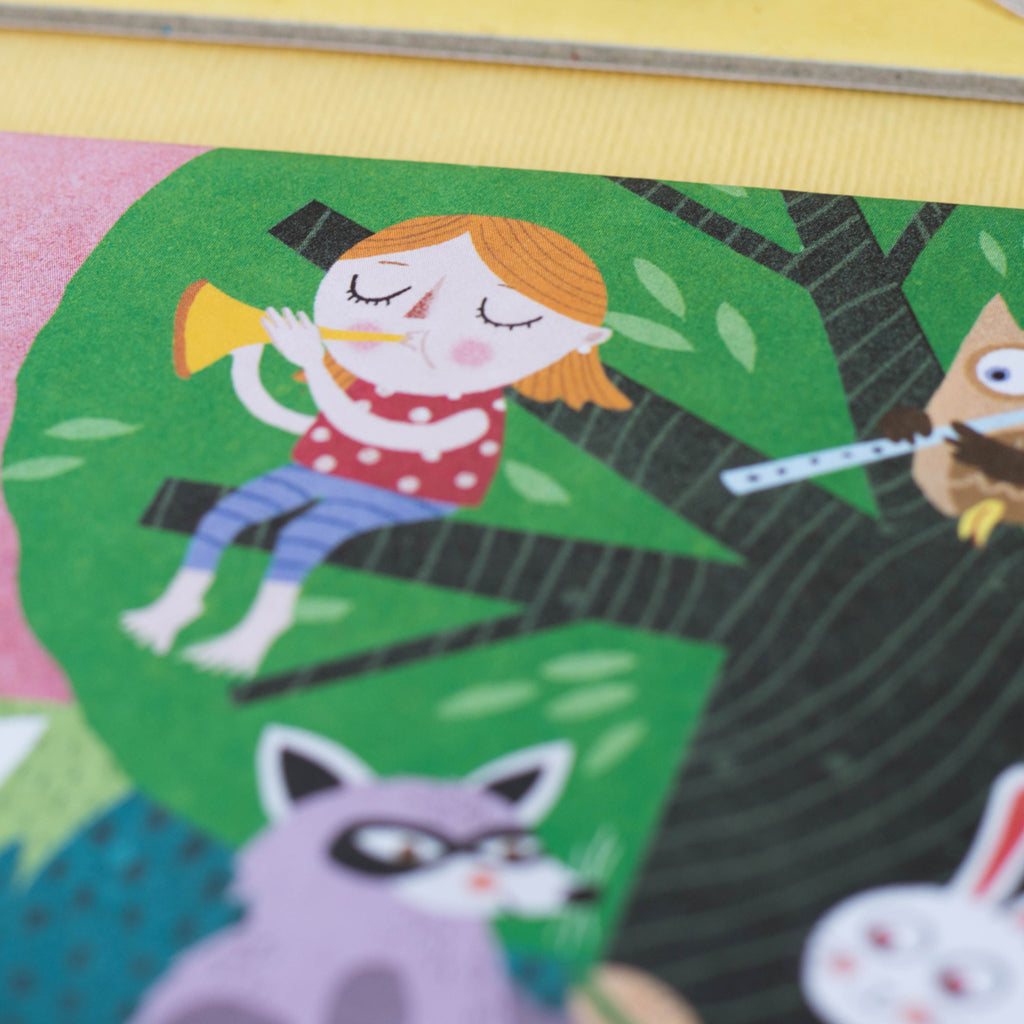Close-up of a girl playing a trumpet in a tree, part of the illustrated scene from Londji Lotto Habitats game.