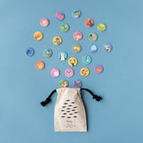 Fabric storage pouch for Lotto Habitats game – A drawstring pouch with a fish pattern and black ties, surrounded by scattered animal tokens.