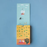 Opened Lotto Habitats game box with illustrated insert – The game’s box opened to reveal a colourful interior with an illustrated desert scene.