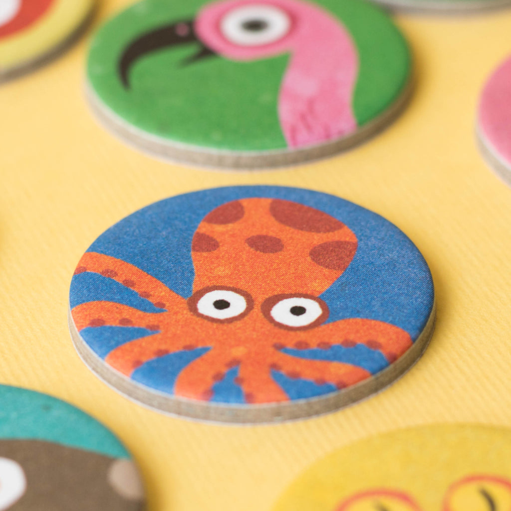 Octopus token from Lotto Habitats game – A close-up of a round game token with a cheerful orange octopus on a blue background.