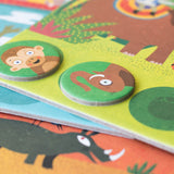 Jungle habitat board with animal tokens – Close-up of the Lotto Habitats game showing a habitat board with a monkey and elephant token.