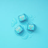 Three blue Blair Glo Pals cubes on a light blue background with water droplets.