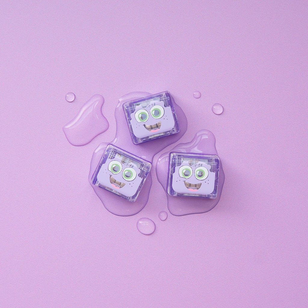 Three purple Lumi Glo Pals light-up cubes on a lilac background with water droplets.