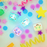 Water-activated Glo Pals Party Pal light-up cubes glowing in colourful water with playful decorations