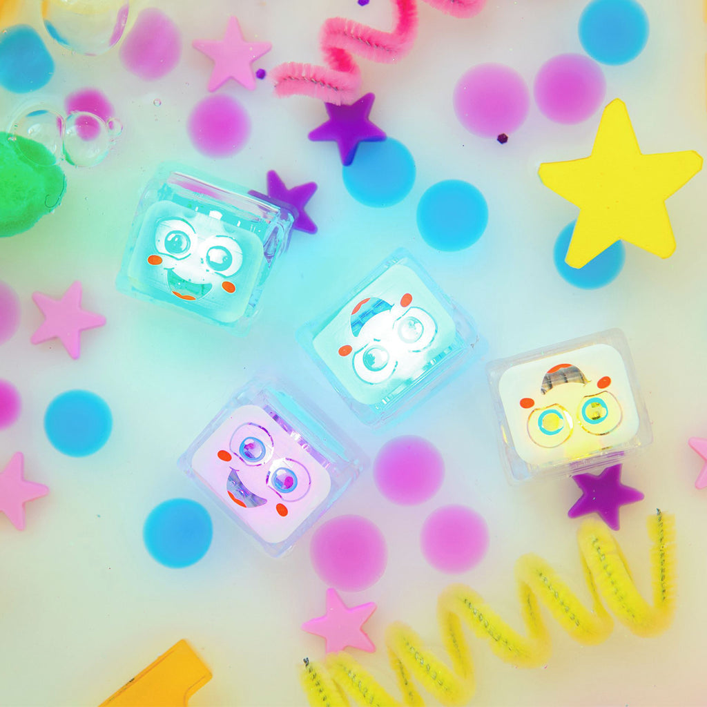 Water-activated Glo Pals Party Pal light-up cubes glowing in colourful water with playful decorations