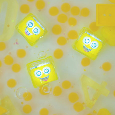 Yellow glowing sensory cubes floating in a water-filled sensory play area.
