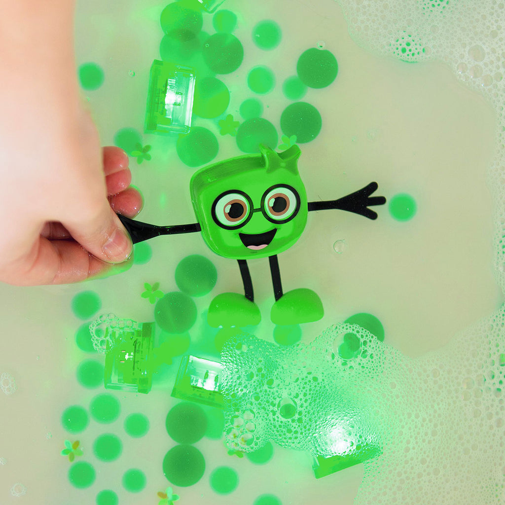 Green Glo Pals Pippa character and light-up cubes glowing in water with floating bubbles and foam.