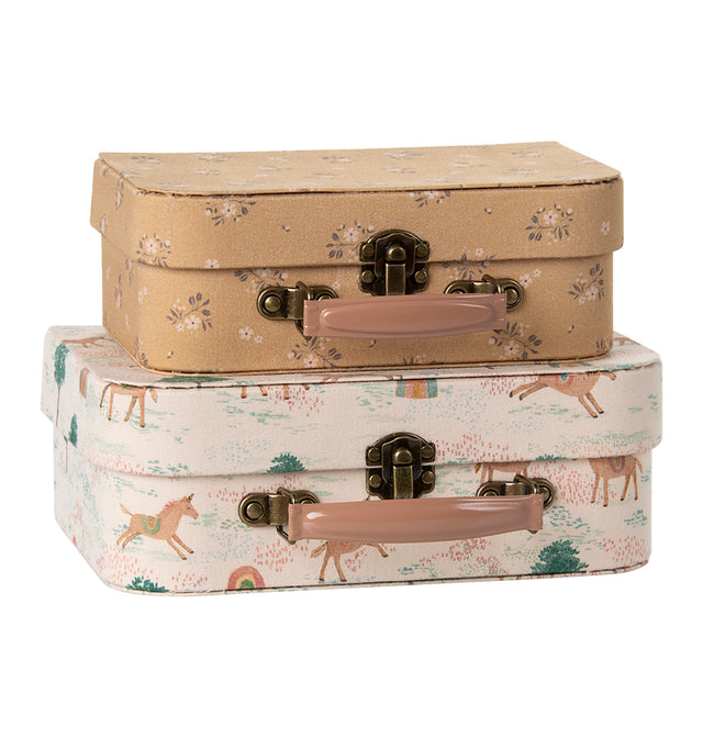 "Stacked Maileg unicorn suitcase set with floral and fantasy designs, perfect for UK children."
