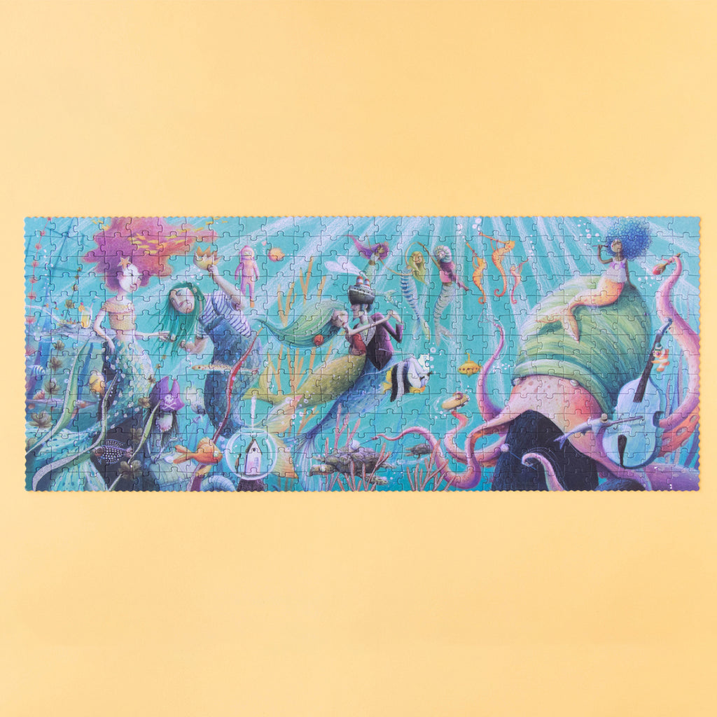 A completed 350-piece Londji My Mermaid puzzle featuring an underwater scene with mermaids and sea creatures.