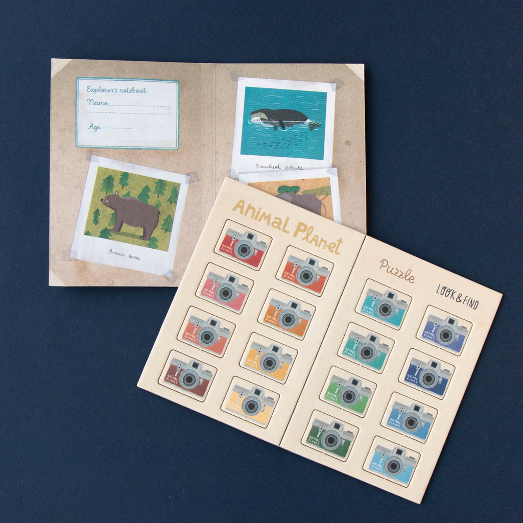 Inside pages of the Animal Planet puzzle guide, featuring an interactive look-and-find game.