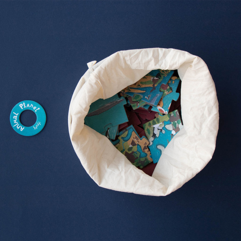 A fabric storage bag filled with puzzle pieces.