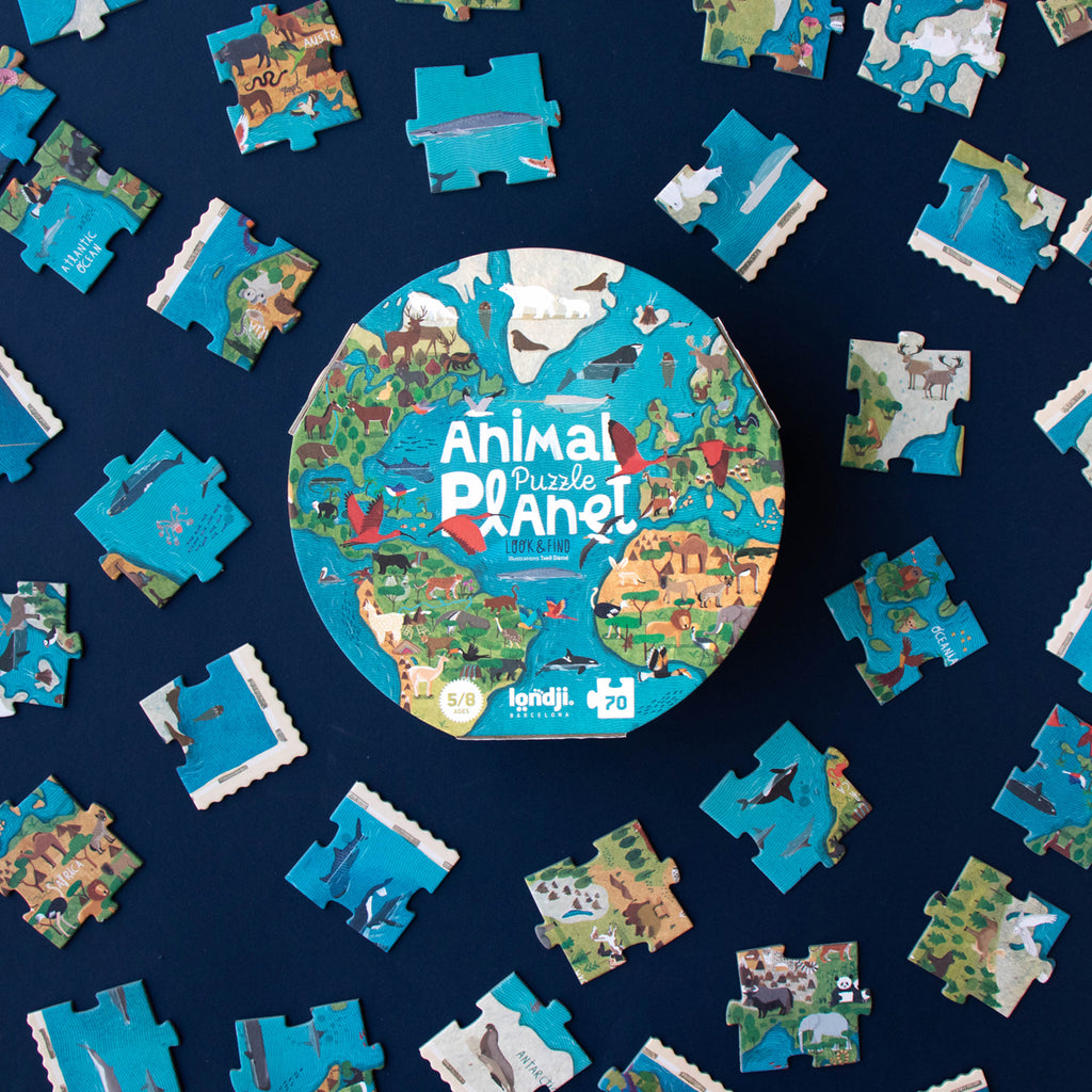 The Animal Planet puzzle box with scattered puzzle pieces around it.