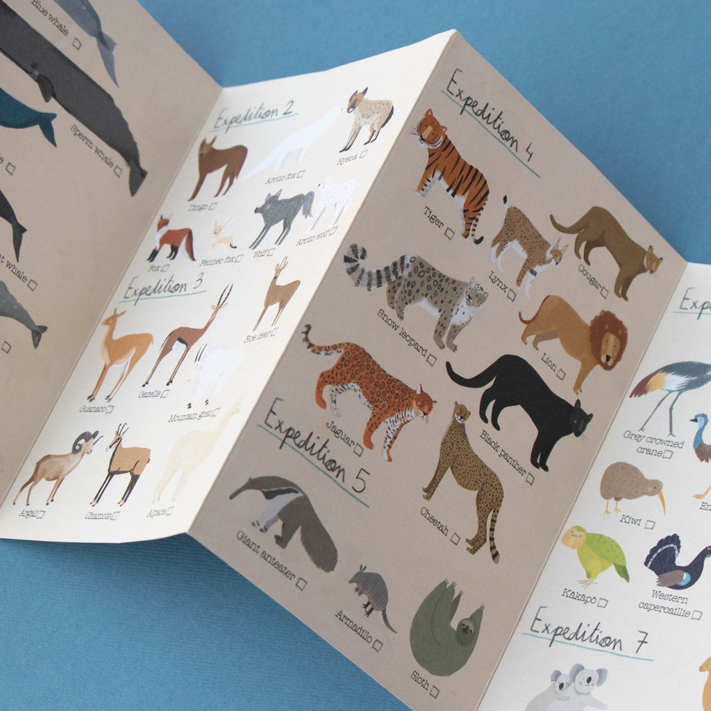 An open expedition guide booklet from the Animal Planet puzzle, displaying beautifully illustrated animals such as tigers, lions, and leopards with checklist boxes for a fun search-and-find activity.