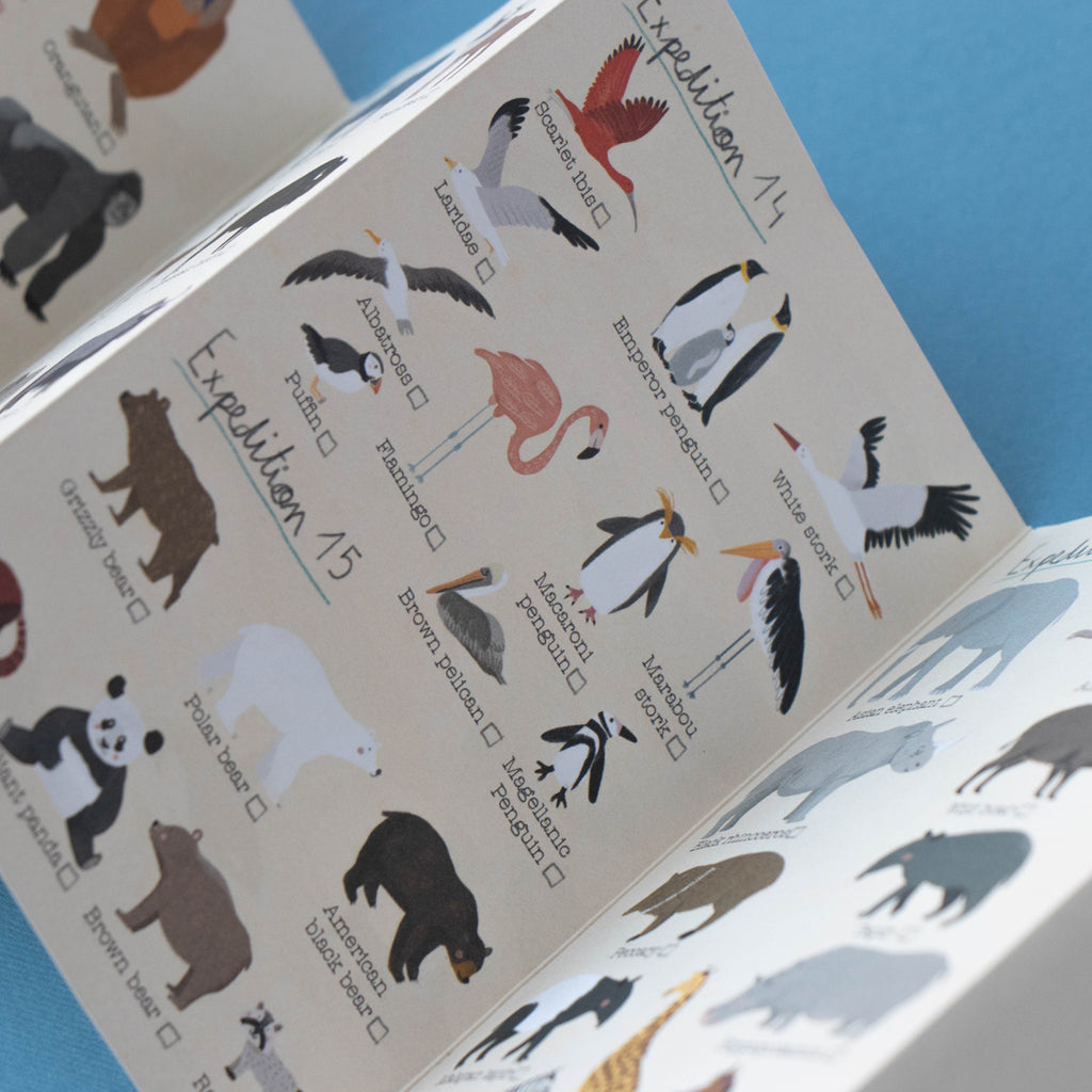 A different section of the Animal Planet puzzle expedition guide, showing illustrated birds including flamingos, penguins, and storks, with checklist boxes for interactive play.