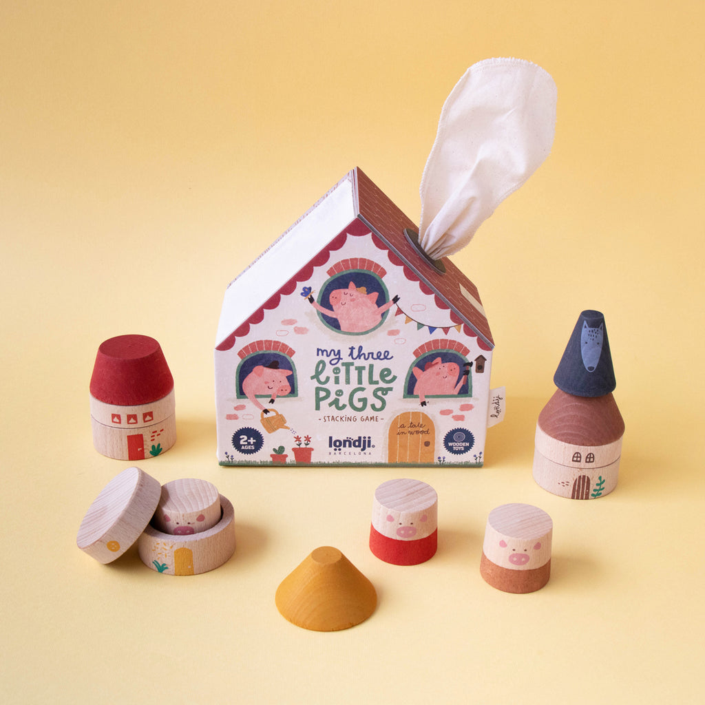 Londji My Three Little Pigs stacking game packaging with wooden pieces arranged in front.