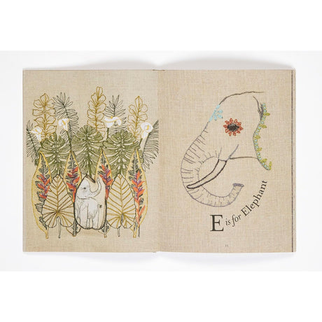 Open book page featuring embroidered artwork of foliage and an elephant head next to "E is for Elephant".