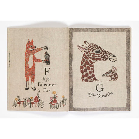 Illustrated alphabet book spread featuring "F is for Falconer Fox" and "G is for Giraffes" on textured pages.