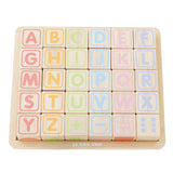 Wooden alphabet blocks set with pastel letters and math symbols displayed on a wooden tray.