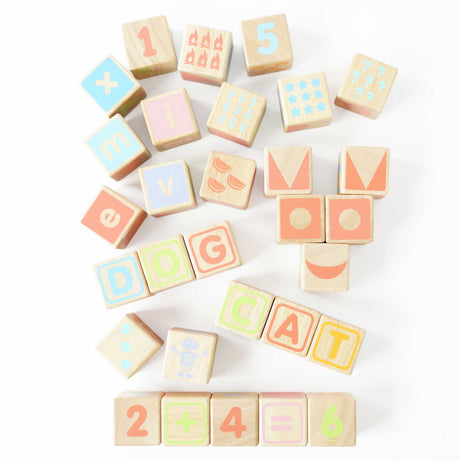 Wooden ABC learning blocks arranged on white background spelling simple words and math equations.