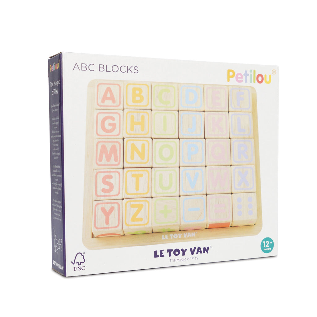Box of colorful wooden ABC blocks labeled "Petilou" by Le Toy Van. Each block displays a letter or symbol, promoting playful learning for ages 12+ months.