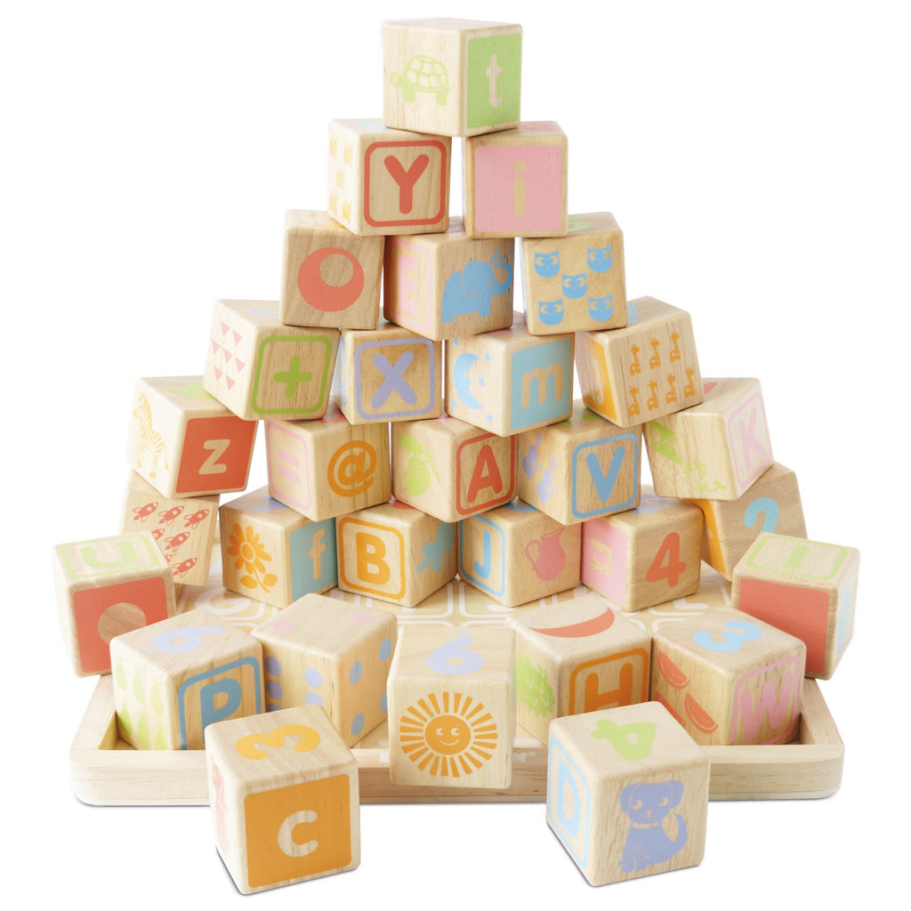 A colorful arrangement of wooden alphabet blocks featuring letters, numbers, and playful illustrations, stacked into a pyramid shape.