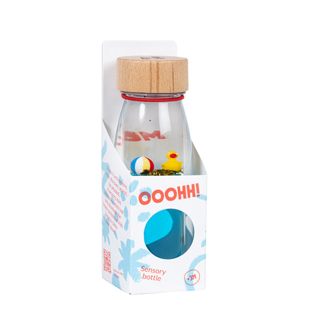 A sensory bottle featuring a small yellow rubber duck and a floating beach ball, packaged and labeled "Ooohh! Sensory Bottle."